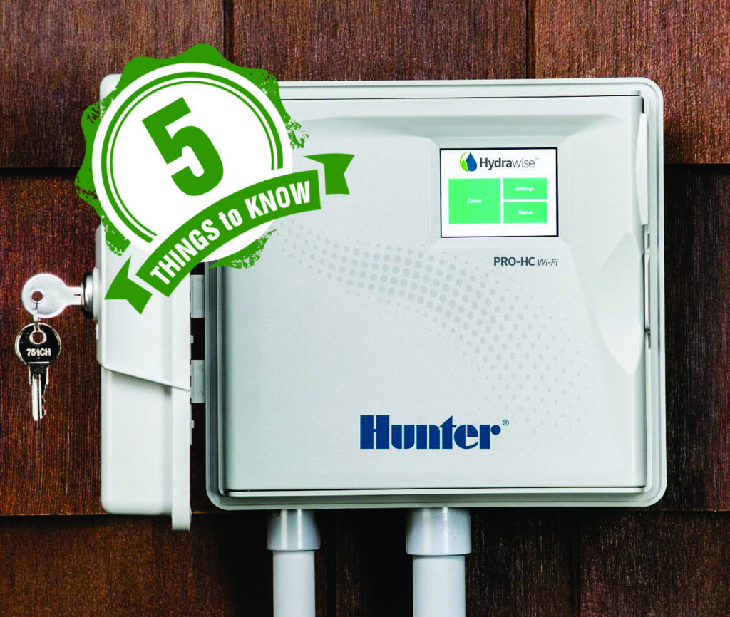 WiFi residential irrigation controller mouted to a wall with two conduit pipes connected to the bottom